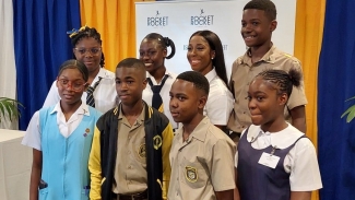 Fraser-Pryce with the latest scholarship recipients from the Pocket Rocket Foundation at the Jamaica Pegasus in Kingston on Thursday.