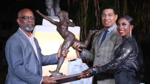 Fraser-Pryce with Prime Minister, the Honourable Andrew Holness and sculptor Barry Watson at the unveiling of her statue six years ago.