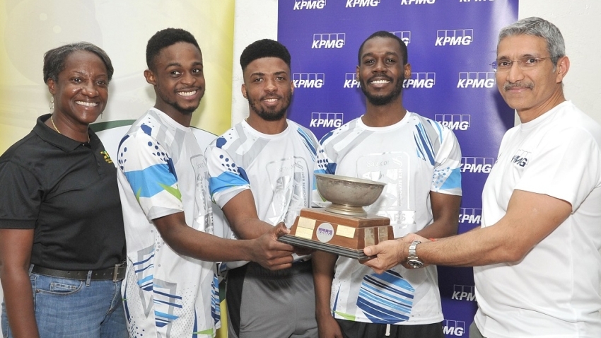AGI team of (L-R) Stephan Morrison, Tahjia Lumley and Julian Morrison receiving the KPMG Squash League trophy from Rajan Trehan (R) - Country Managing Partner of KPMG while Karen Anderson (L) - president of the Jamaica Squash Association shared in the moment. AGI defeated Almost Capable to be crowned champion of the league last Friday at the Liguanea Club in Kingston.. 