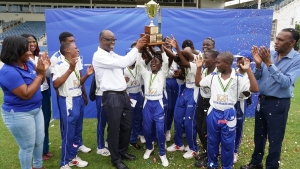 Members of the St. Mary U15 team celebrating their first-ever win of the Kingston Wharves U15 Cricket Competition following their seven-wicket victory over St Elizabeth at Sabina Park on Thursday.  Albert McDonald, Commercial and Logistics Manager at Kingston Wharves presented the trophy to the team.  Sharing in the occasion were Simone Forbes (L) and Prudence Barnes (2nd) of Kingston Wharves as well as Billy Heaven (R) President of the Jamaica Cricket Association.