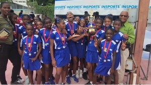 INSPORTS’ Acting Executive Director Major Desmon Brown (right) poses with members of the winning St Patrick’s Primary School team after they defeated Mona Heights 13-5 to win the INSPORTS Primary Schools Netball Kingston and St Andrew Division.