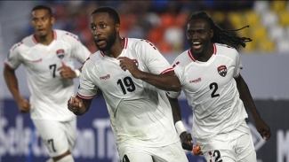 Malcolm Shaw (foreground) and Soca Warriors teammates celebrate.