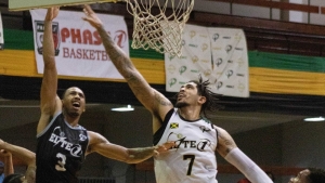 Waves&#039; seven-footer Tyran Walker (#7) goes airborne to block Storms&#039; Jayrn Johnson (#3) while Derjean Royal (L) and Lushane Wilson (R) of Waves look on during Waves&#039; win over Storm on Wednesday, January 26,  at the National Arena.