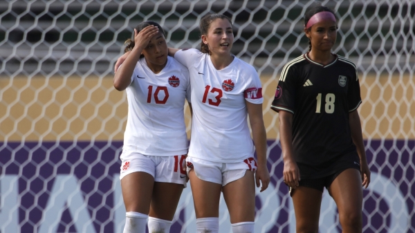 Jamaica&#039;s Amelia Van Zanten cuts a dejected figure as Canada&#039;s Olivia Smith (left), celebrates a goal with captain Florianne Jourde during their opening Group A game at Felix Sanchez Stadium in Santo Domingo, Dominican Republic on Friday. 
