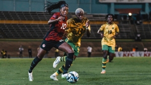Canada&#039;s Ashley Lawrence (left) gets away from Jamaica&#039;s Deneisha Blackwood during their first-leg Olympic qualifying playoff contest at the National Stadium on Friday.